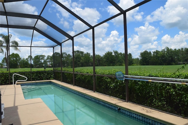 view of swimming pool featuring glass enclosure