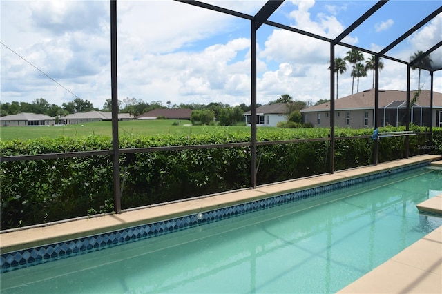 view of swimming pool with glass enclosure