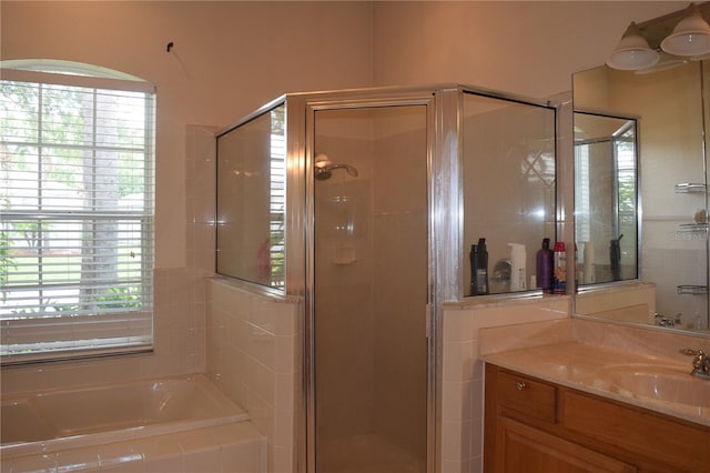 bathroom with vanity, plenty of natural light, and plus walk in shower