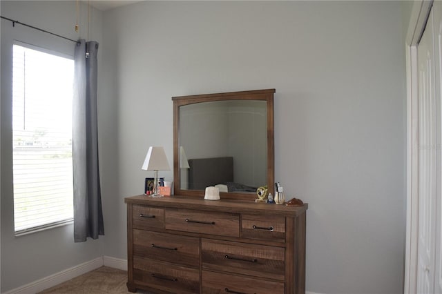 carpeted bedroom featuring multiple windows