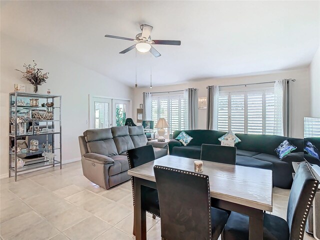 living room featuring ceiling fan, lofted ceiling, light tile patterned floors, and french doors