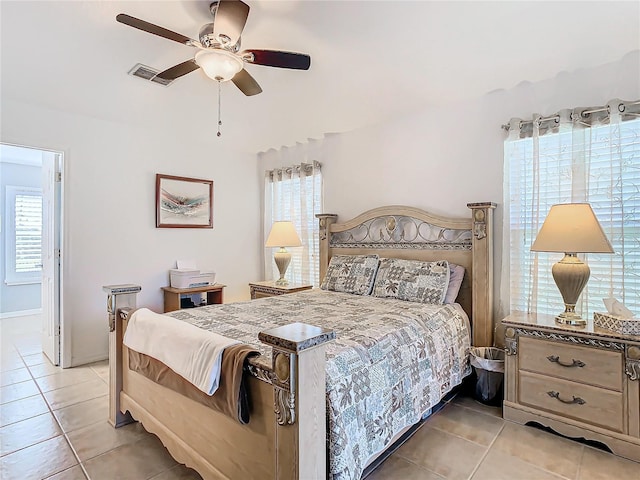 tiled bedroom with ceiling fan