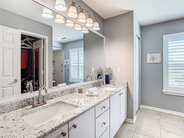 bathroom with tile patterned flooring, vanity, and toilet