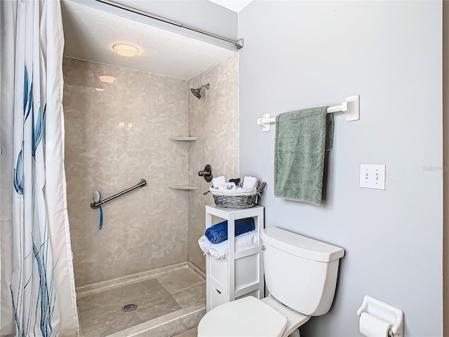 bathroom featuring curtained shower and toilet