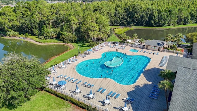 view of swimming pool with a water view and a patio