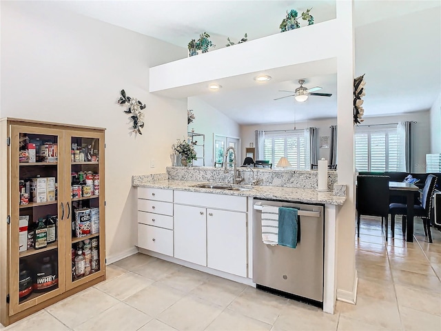 11247 Corey Pavin Ln, San Antonio, FL 33576 - kitchen with white cabinets, a sink, light tile patterned flooring, dishwasher, and a peninsula