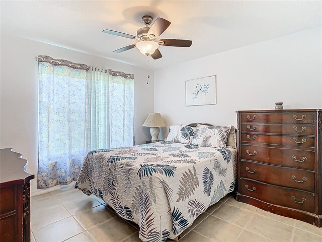 11247 Corey Pavin Ln, San Antonio, FL 33576 - bedroom featuring light tile patterned floors and ceiling fan