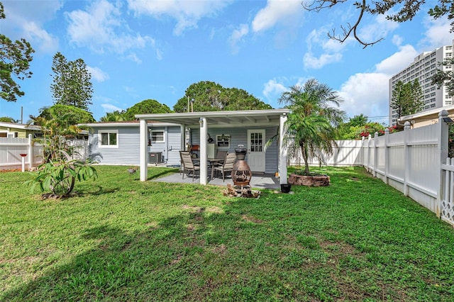 back of house featuring a yard, a patio, and central AC