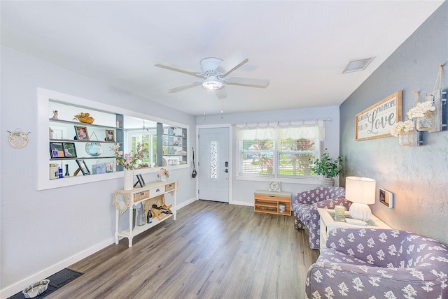 sitting room featuring hardwood / wood-style floors, plenty of natural light, and ceiling fan