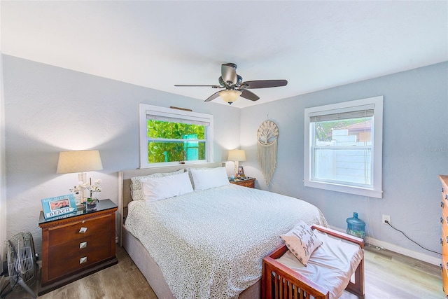 bedroom with ceiling fan and light hardwood / wood-style floors