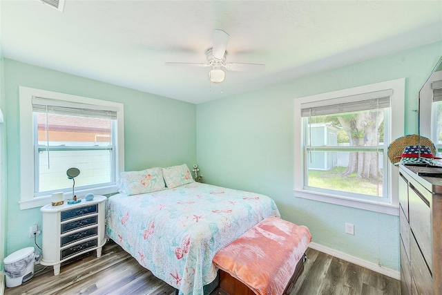 bedroom with ceiling fan and dark wood-type flooring