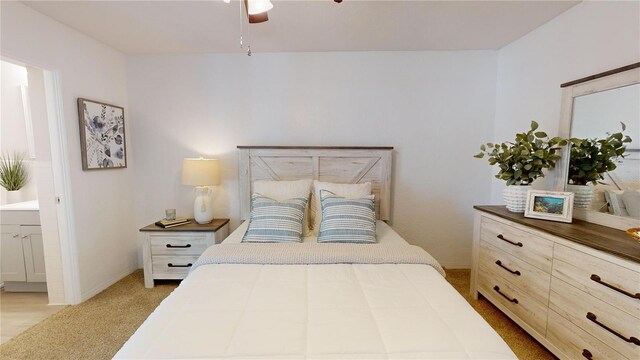 carpeted bedroom featuring ensuite bathroom and ceiling fan