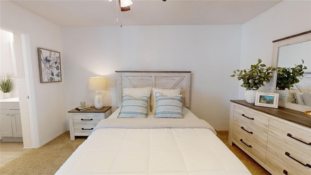 carpeted bedroom with ceiling fan and ensuite bathroom