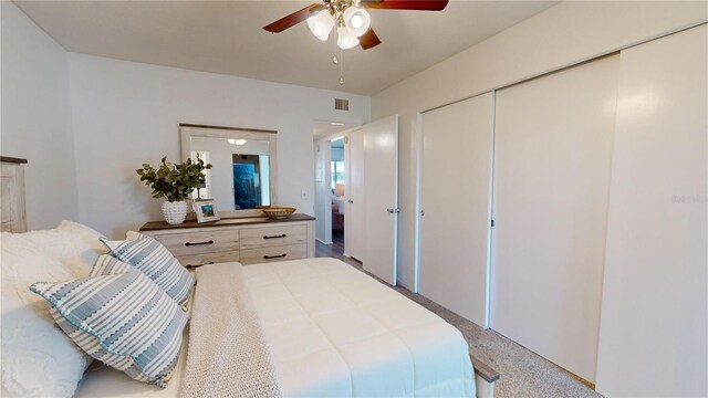 bedroom with light carpet, a closet, and ceiling fan