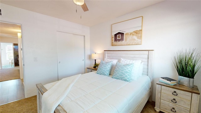 bedroom featuring a closet, ceiling fan, and carpet flooring