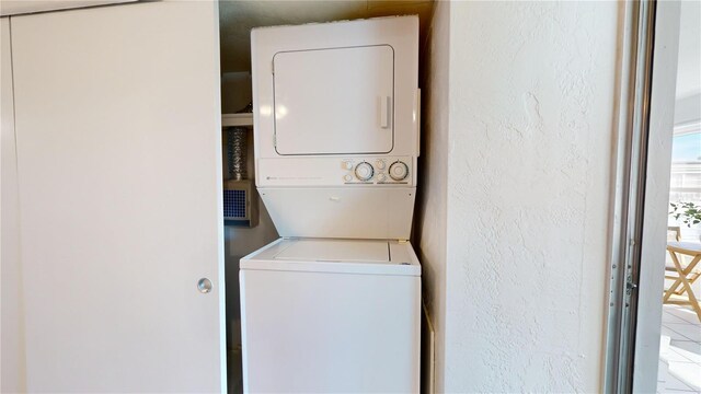 laundry room featuring stacked washer and clothes dryer