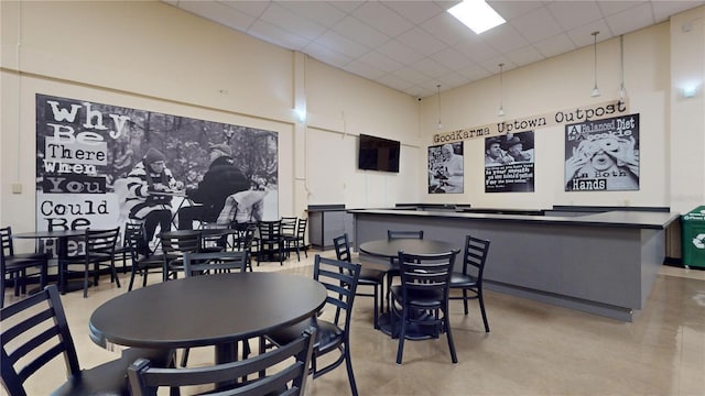 dining space featuring a drop ceiling