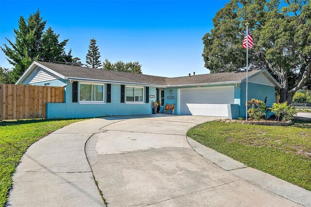 ranch-style house with a garage and a front yard