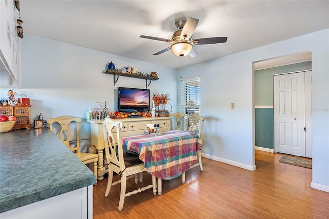 dining space featuring ceiling fan and hardwood / wood-style flooring