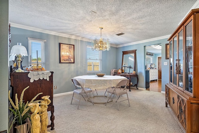 dining area with ornamental molding, an inviting chandelier, a textured ceiling, and light carpet