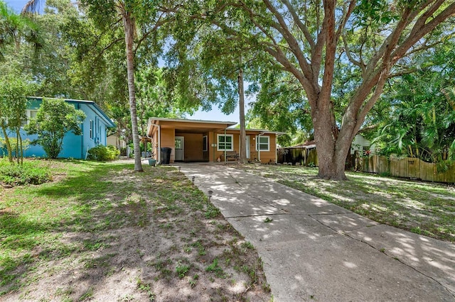 single story home featuring a front yard and a carport