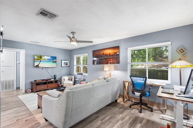 living room with ceiling fan and hardwood / wood-style flooring