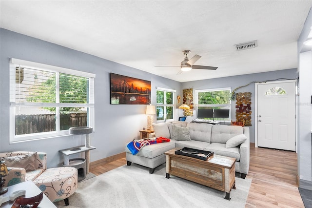 living room featuring ceiling fan and light hardwood / wood-style floors