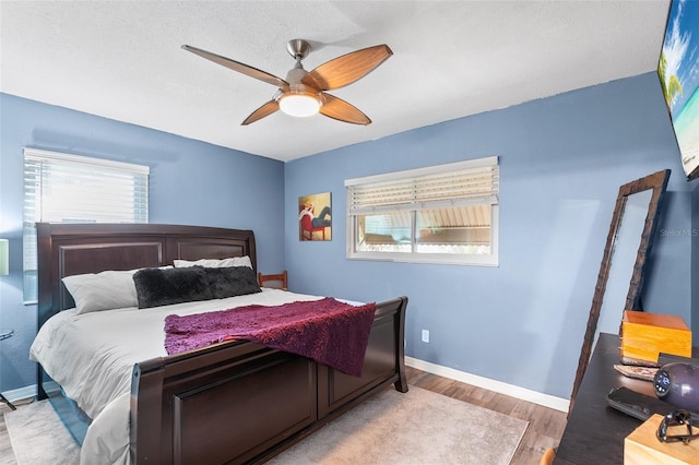 bedroom with light hardwood / wood-style flooring and ceiling fan