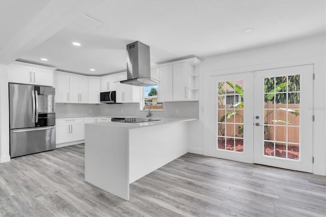 kitchen featuring french doors, white cabinets, kitchen peninsula, stainless steel appliances, and extractor fan