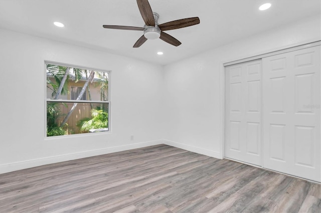 unfurnished bedroom with light wood-type flooring, a closet, and ceiling fan