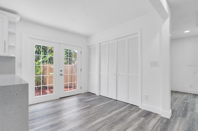 interior space with light hardwood / wood-style flooring and french doors