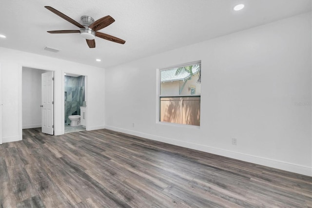 spare room with ceiling fan and dark hardwood / wood-style floors