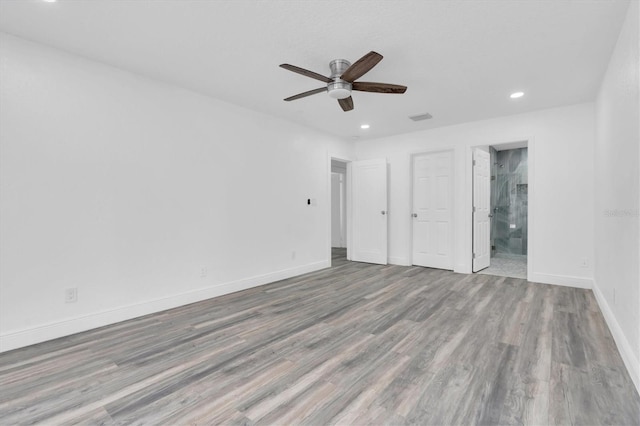 unfurnished bedroom with ensuite bathroom, ceiling fan, and light hardwood / wood-style floors