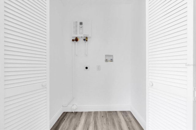 washroom with electric dryer hookup, light hardwood / wood-style flooring, and washer hookup