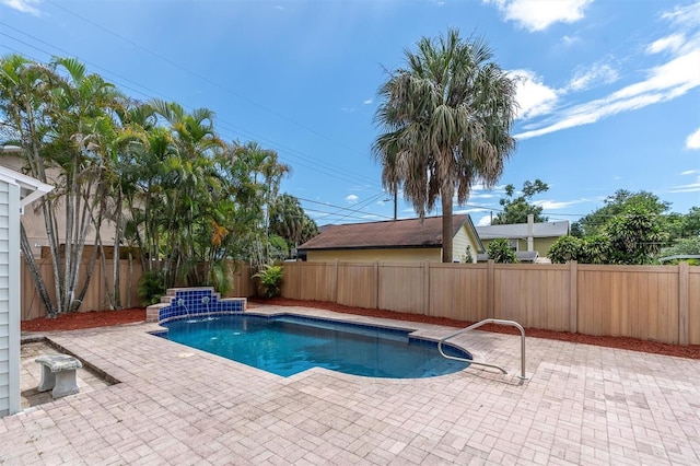 view of swimming pool featuring pool water feature and a patio