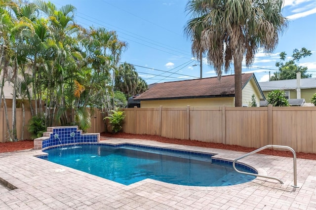 view of pool featuring pool water feature and a patio