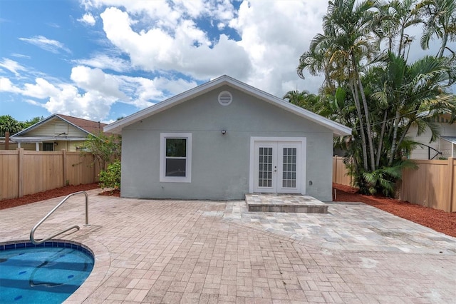 rear view of house with a patio area and french doors