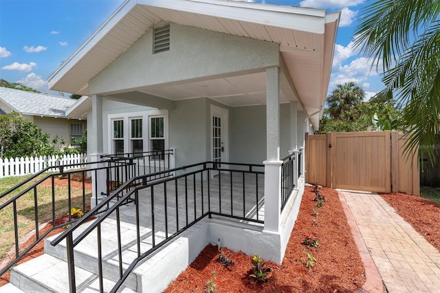 view of side of property featuring covered porch