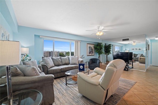 living room with light tile patterned floors and ceiling fan