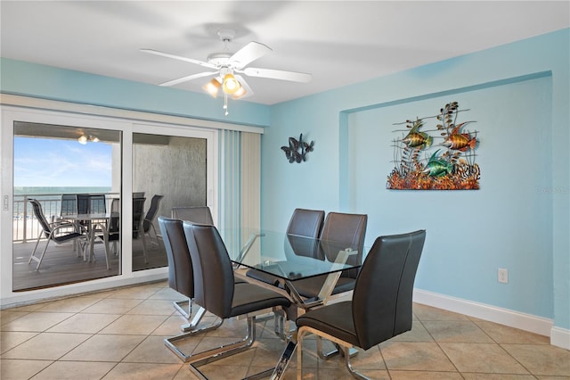 tiled dining room featuring ceiling fan