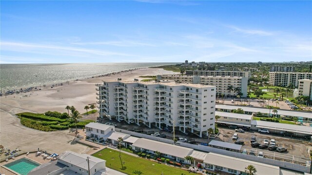 drone / aerial view with a water view and a beach view