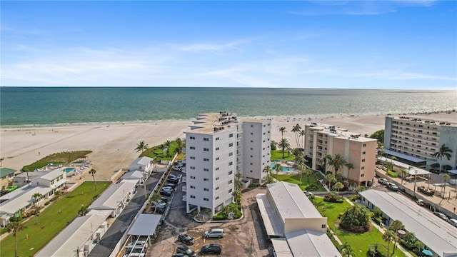 drone / aerial view with a water view and a beach view