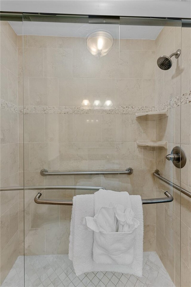 bathroom with a shower with door