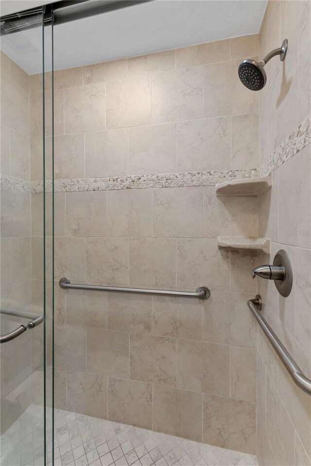 bathroom featuring a shower with door