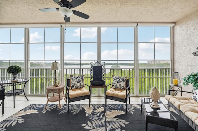 sunroom / solarium featuring ceiling fan