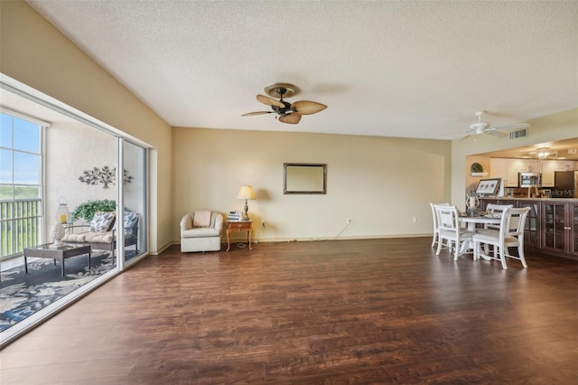 living area featuring dark hardwood / wood-style flooring and a textured ceiling