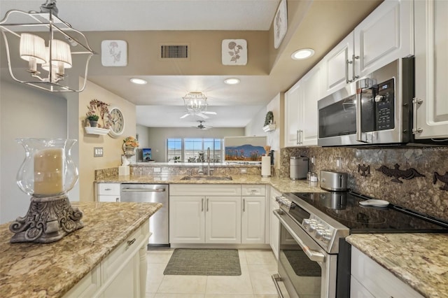 kitchen featuring a notable chandelier, sink, white cabinetry, and stainless steel appliances