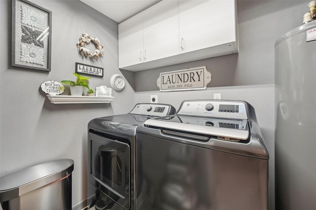 clothes washing area featuring cabinets and independent washer and dryer