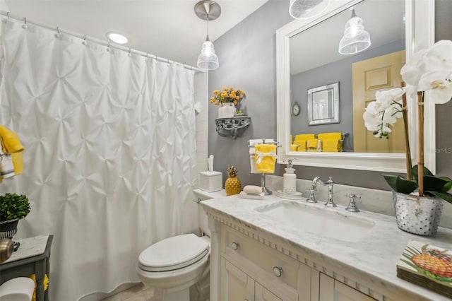 bathroom with tile patterned floors, vanity, and toilet