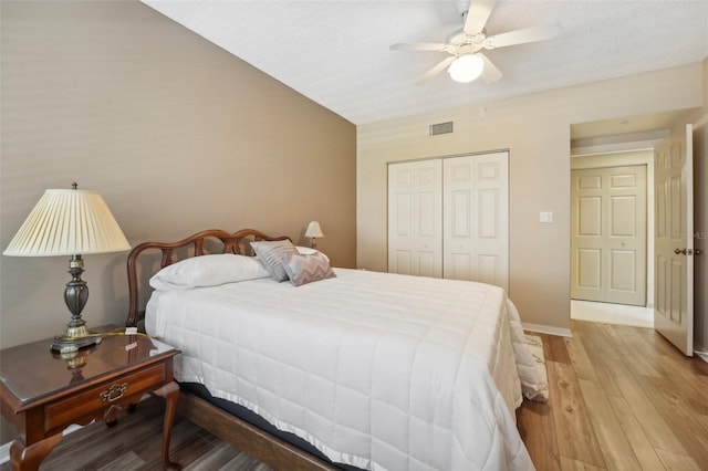 bedroom featuring ceiling fan, a closet, and light hardwood / wood-style flooring